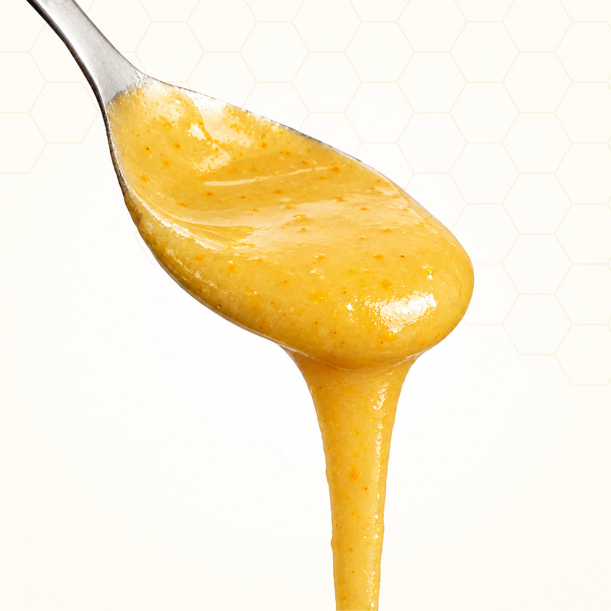 Mango mit Honig - fruchtig & mild – Konsistenz auf einem Silberlöffel